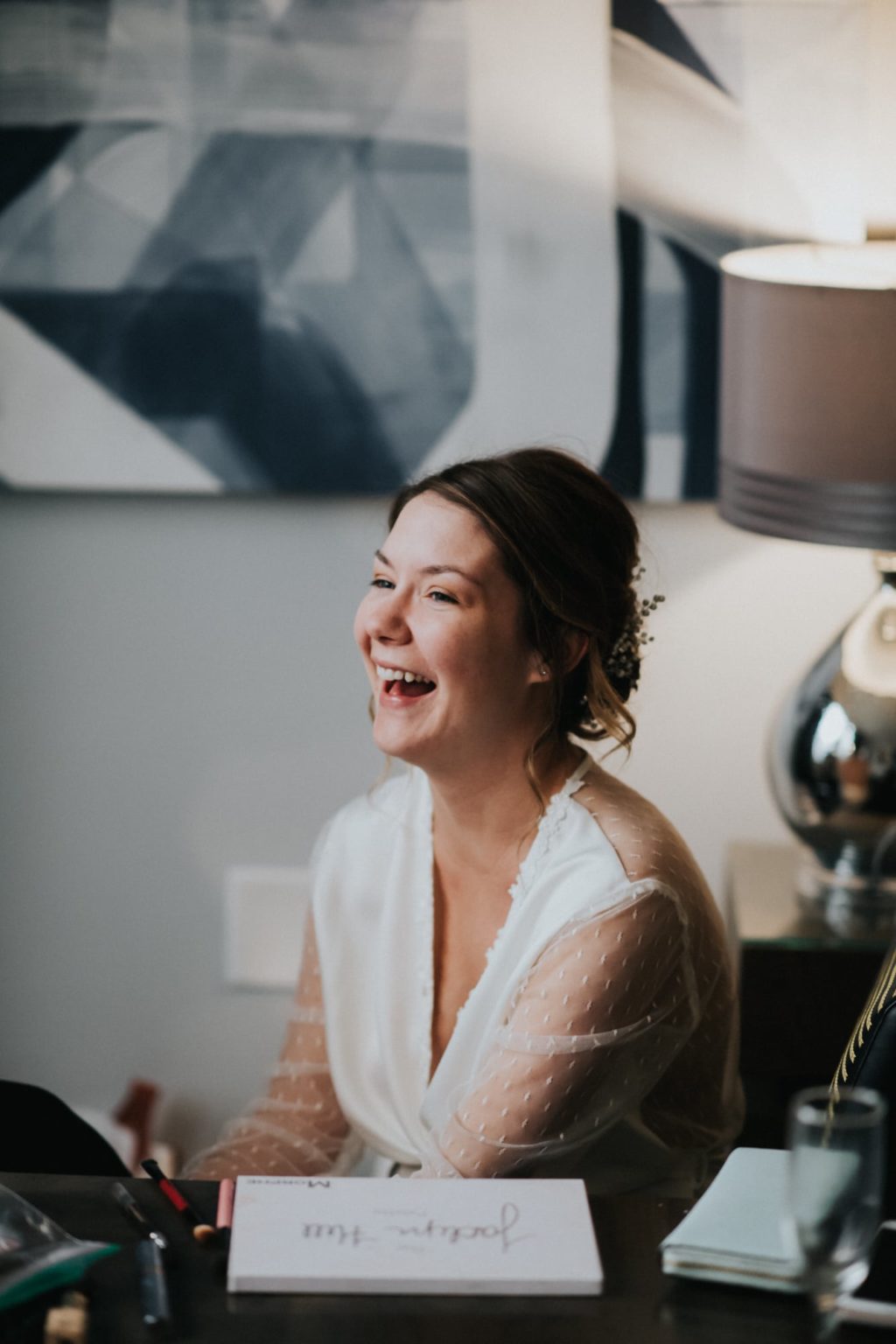 bride laughing in hotel room