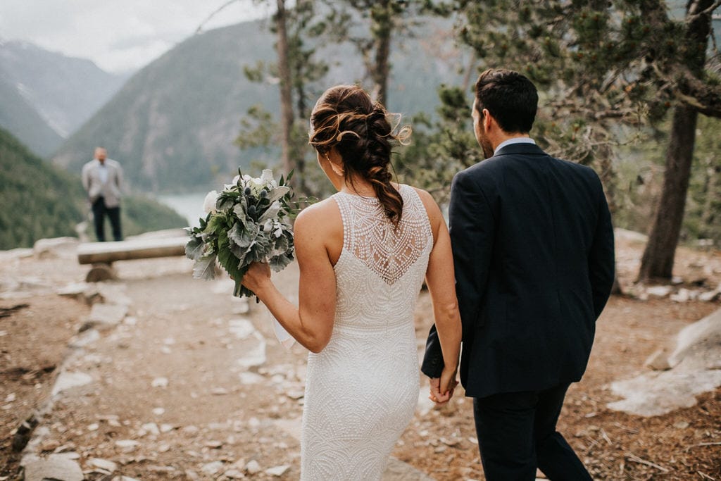 bride and groom walking down aisle together for their diablo lake elopement