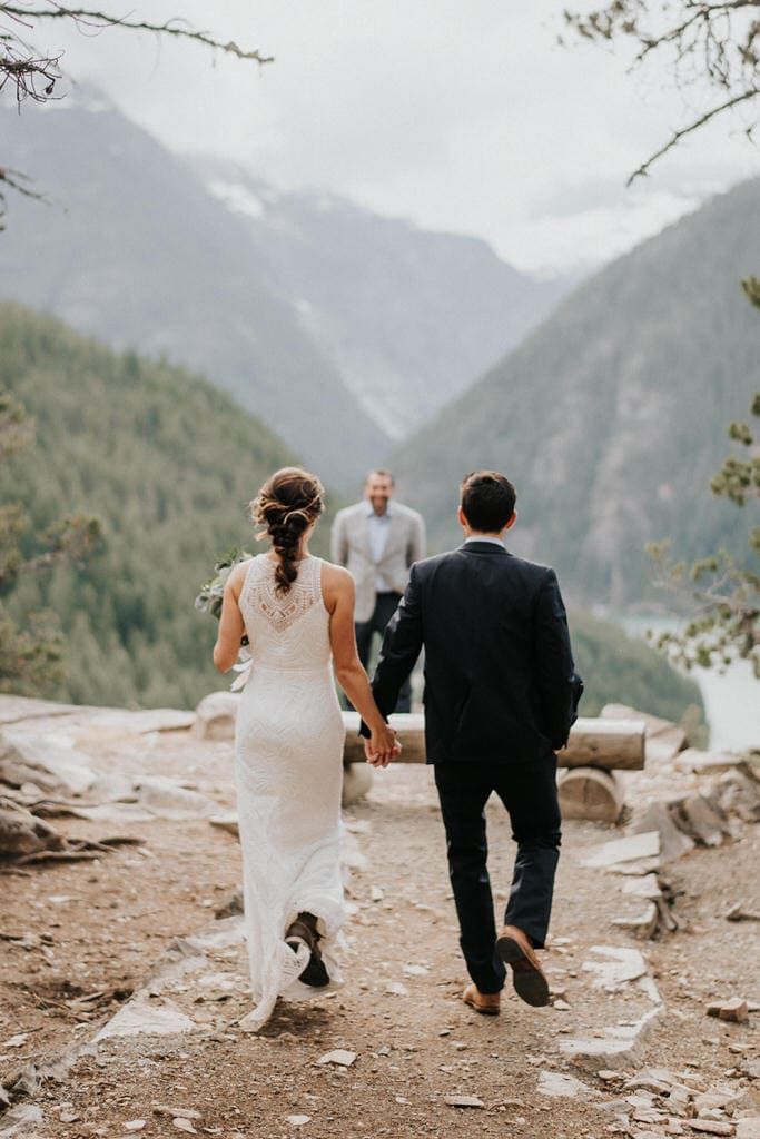 bride and groom walking down aisle together to diablo lake