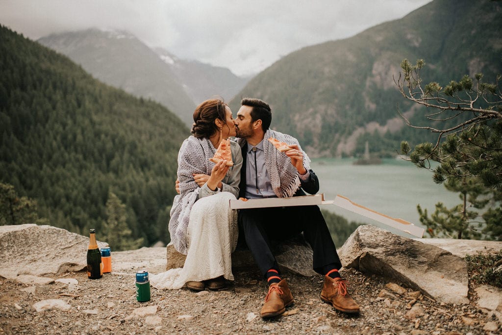 bride and groom sharing pizza after diablo lake elopement