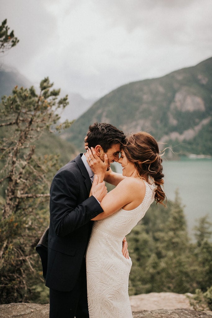 bride and groom with foreheads together at diablo lake