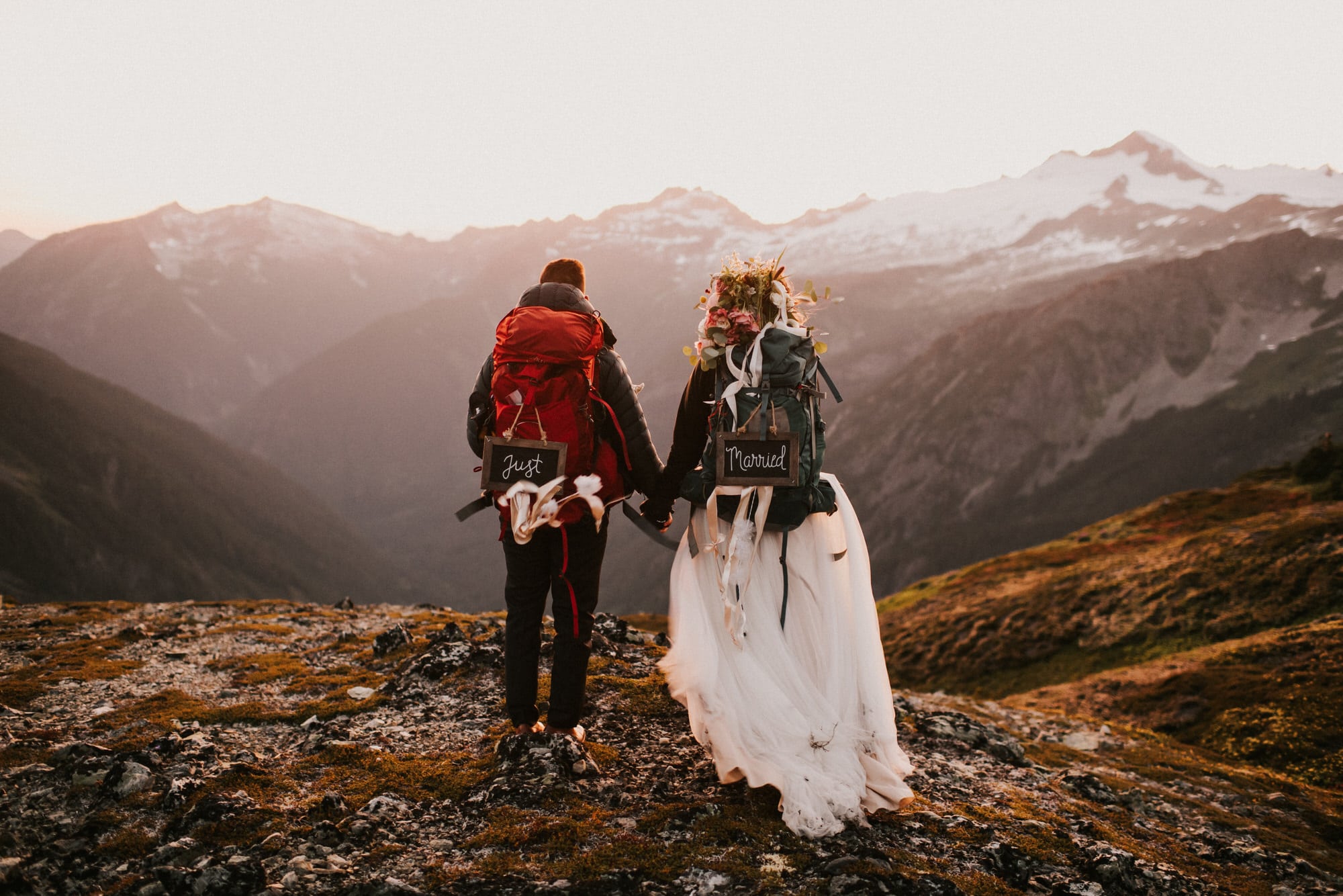 Bride and Groom holding hands watching the sunset during their north cascades adventure wedding
