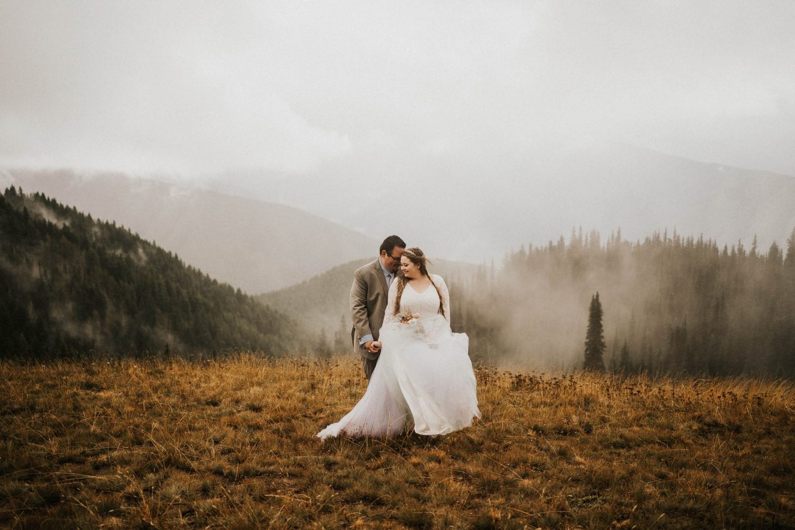 groom holding bride from behind at Hurricane ridge elopement
