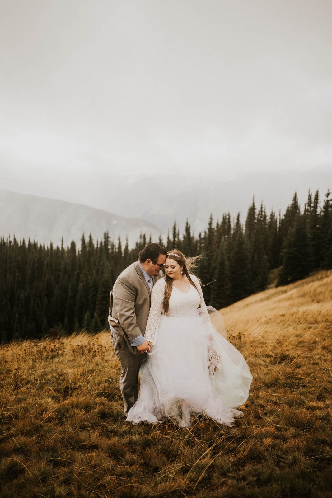 groom holding bride from behind at hurricane ridge elopement
