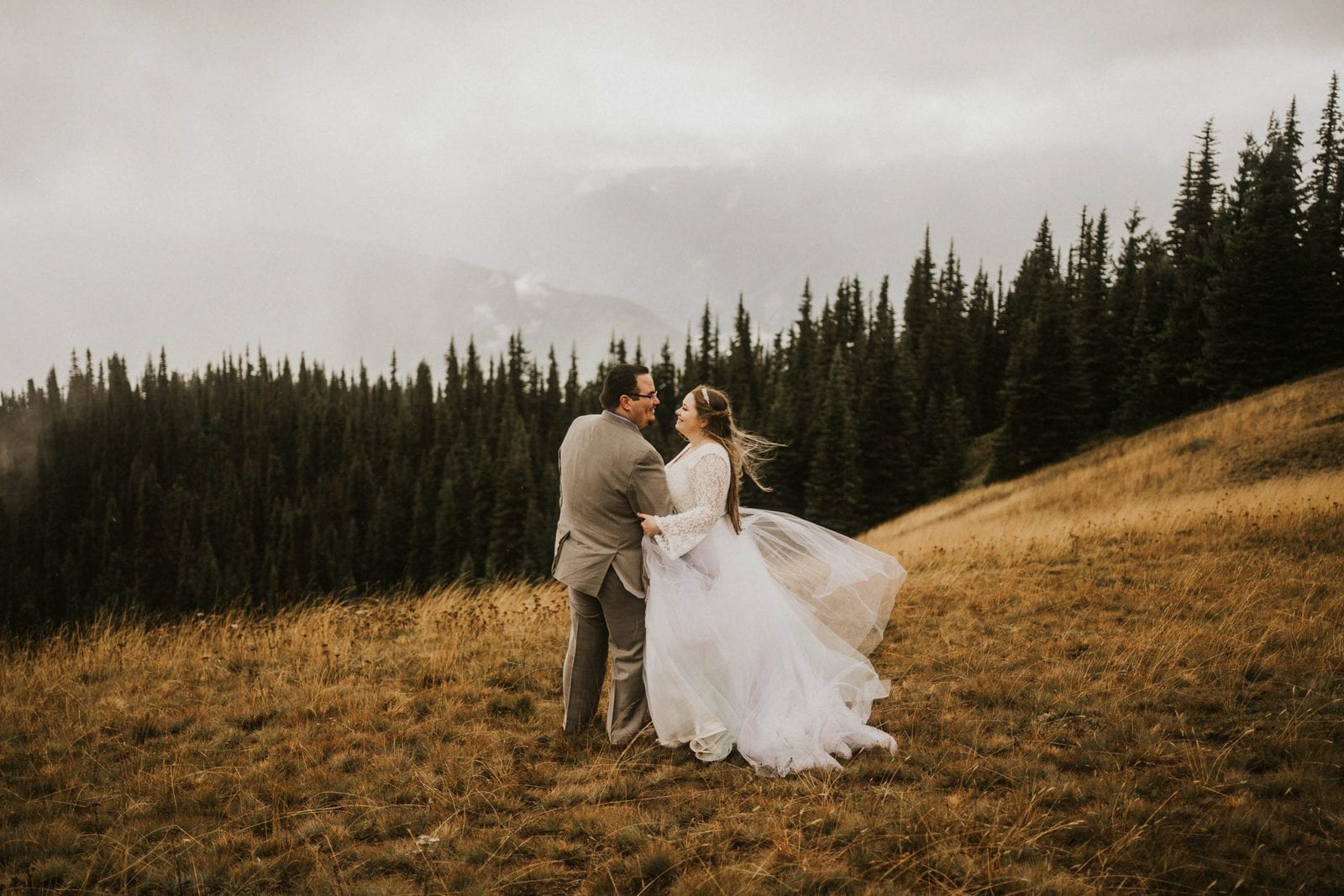 bride and groom holding each other at hurricane ridge elopement