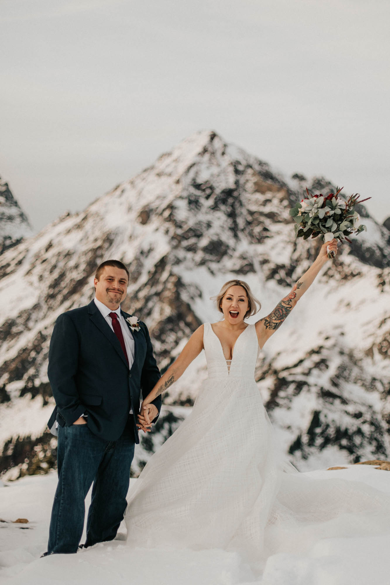 bride and groom cheering after ceremony at mount baker elopement