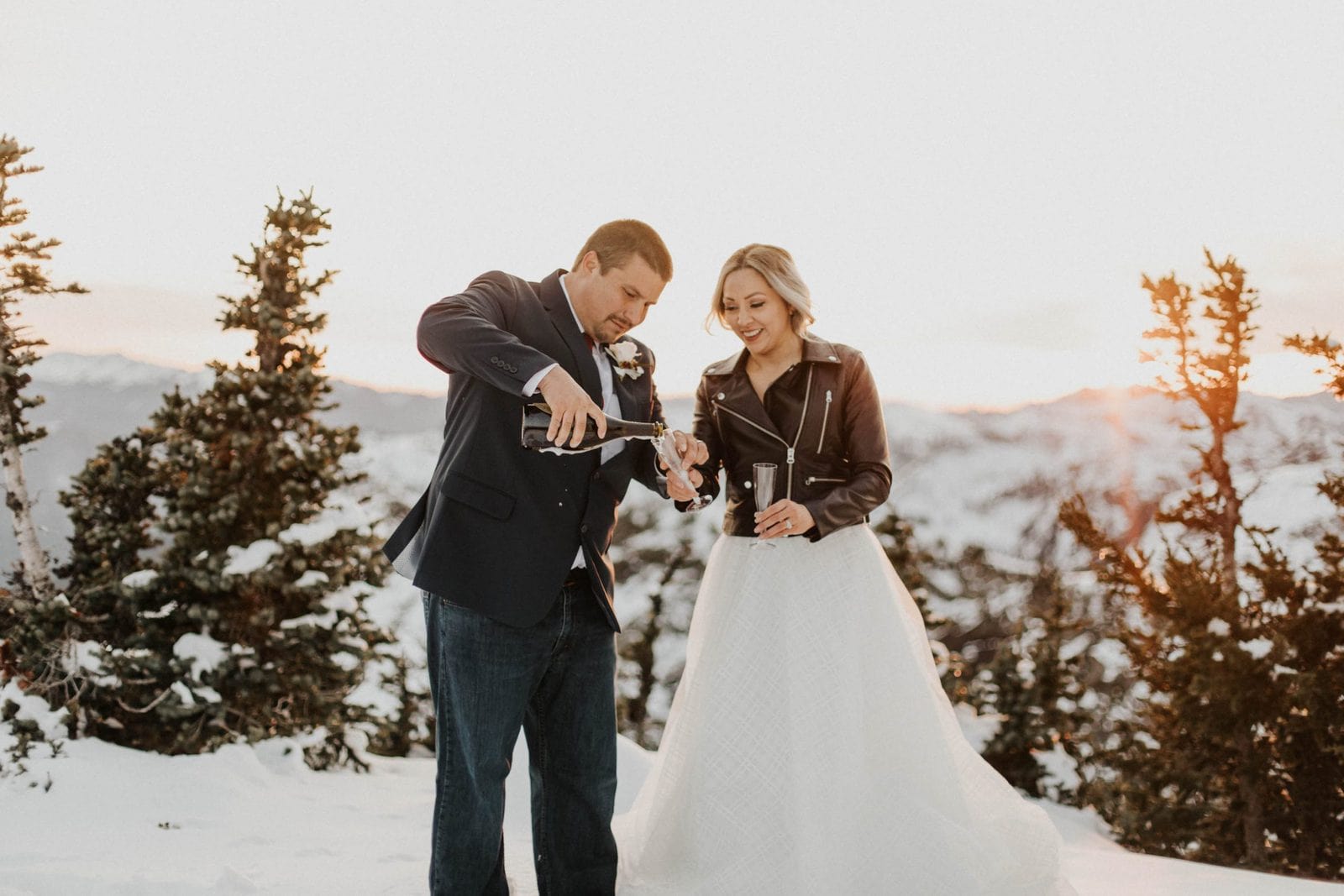 groom pouring champagne into glasses