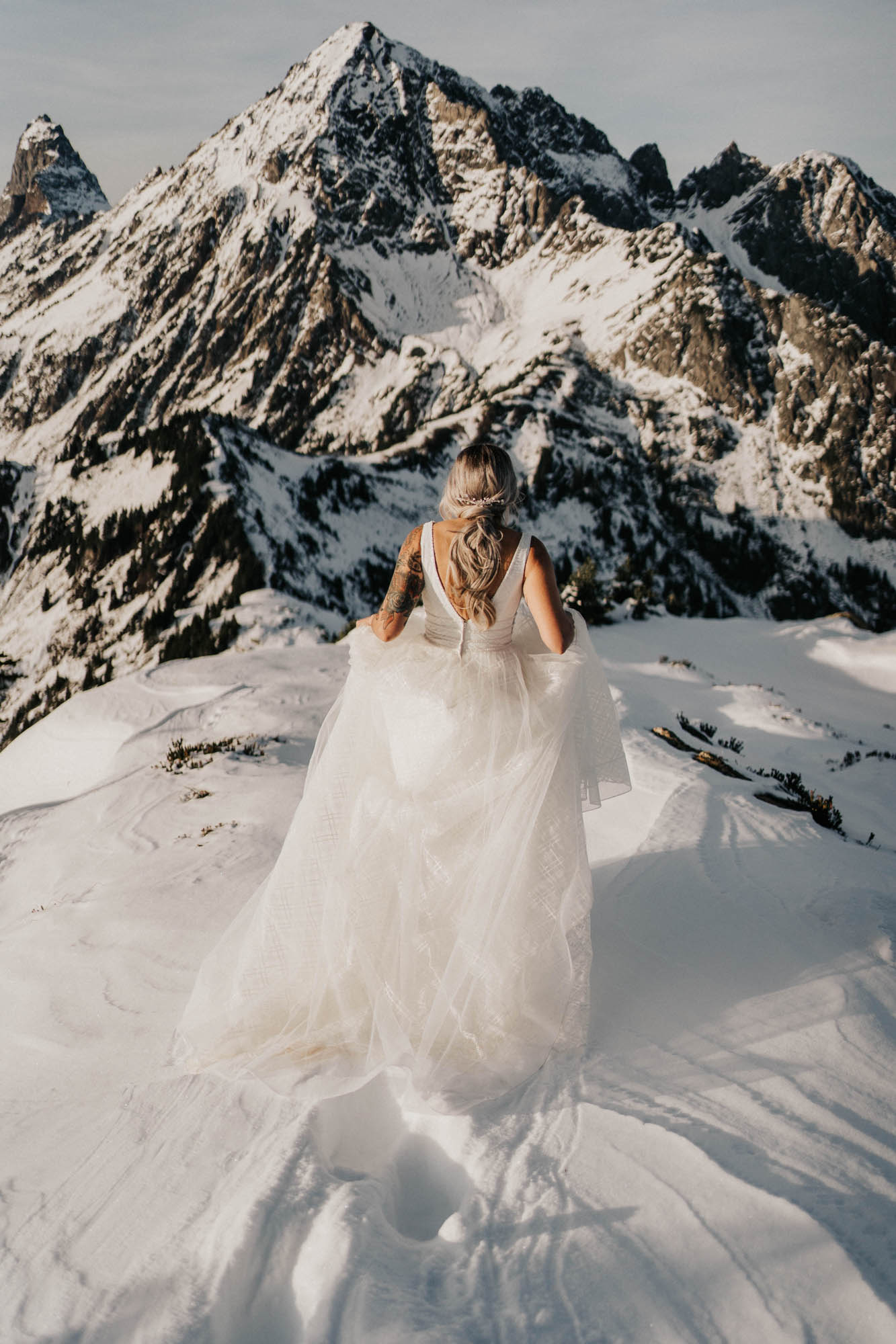 bride walking toward the mountains at mount baker elopement