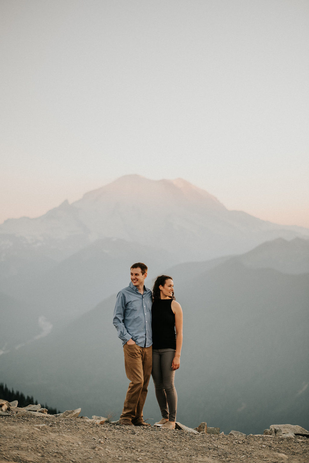 couple taking photos at crystal mountain with mount rainier in the background