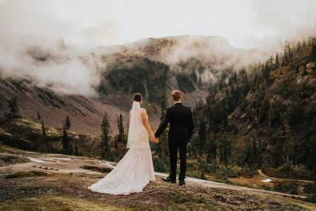 bride and groom looking out at mountain views at artist point elopement